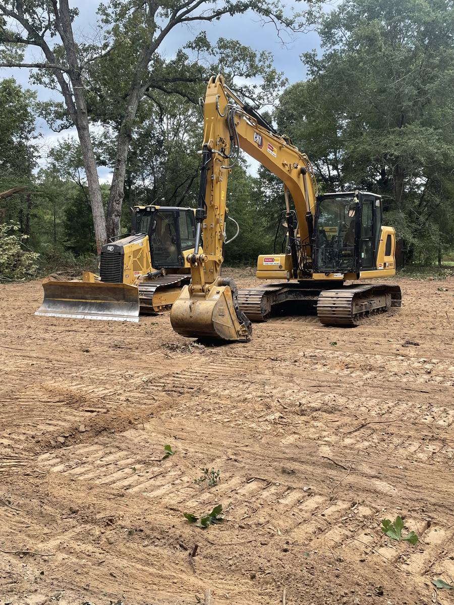 Dozer and excavator on a cleared lot
